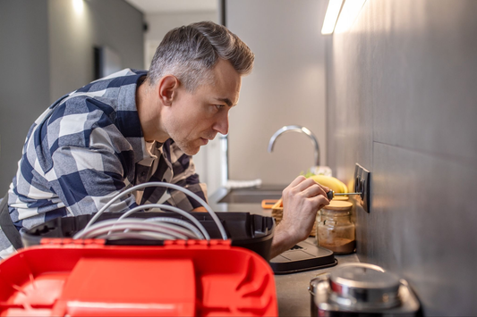 male technician fixing power socket